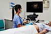 A képen egy orvos látható, aki hasi ultrahangvizsgálatot végez egy betegen.